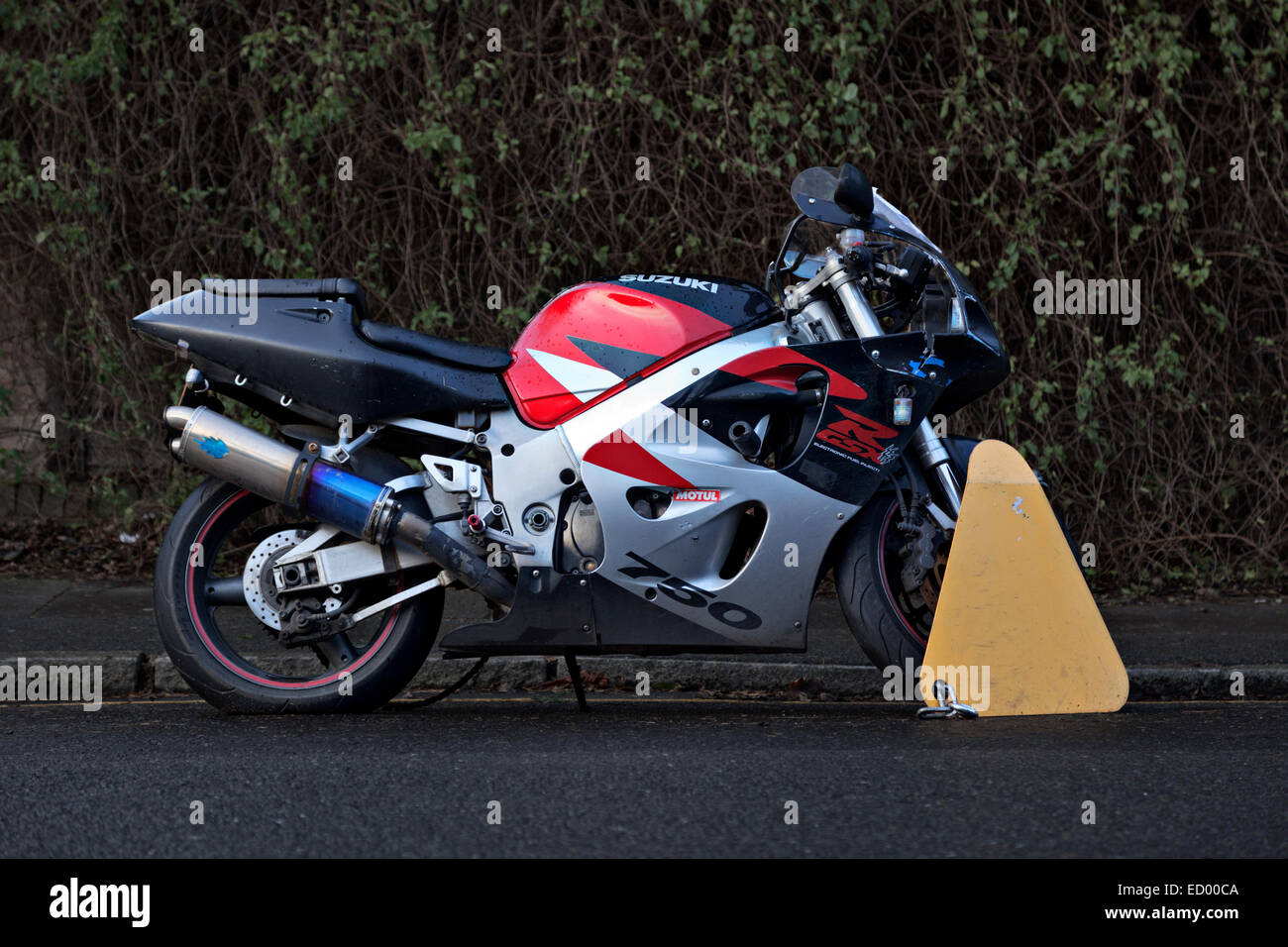 Motociclo bloccato a causa di un parcheggio su una linea gialla Foto Stock