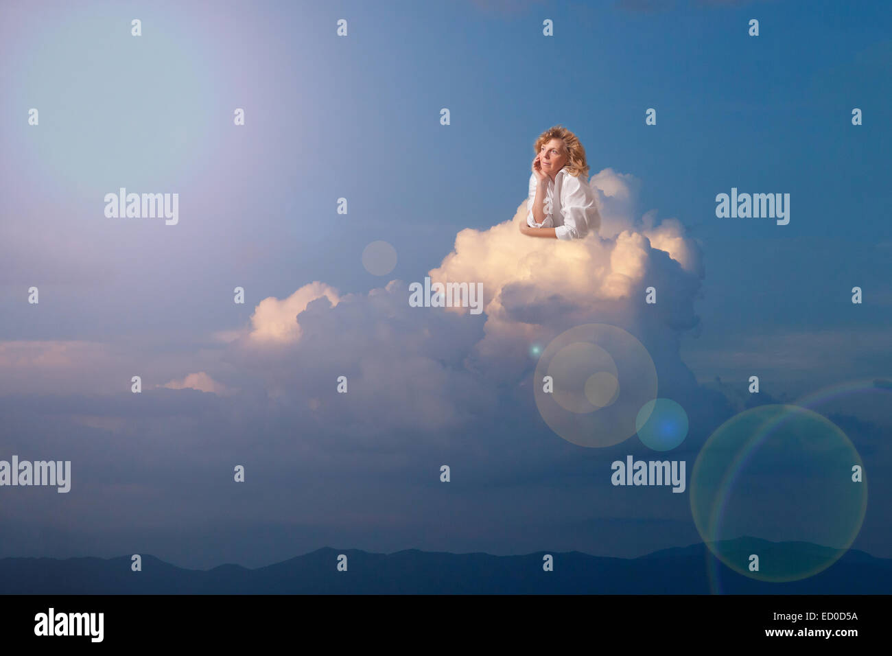 Donna bionda sognando su cloud Foto Stock