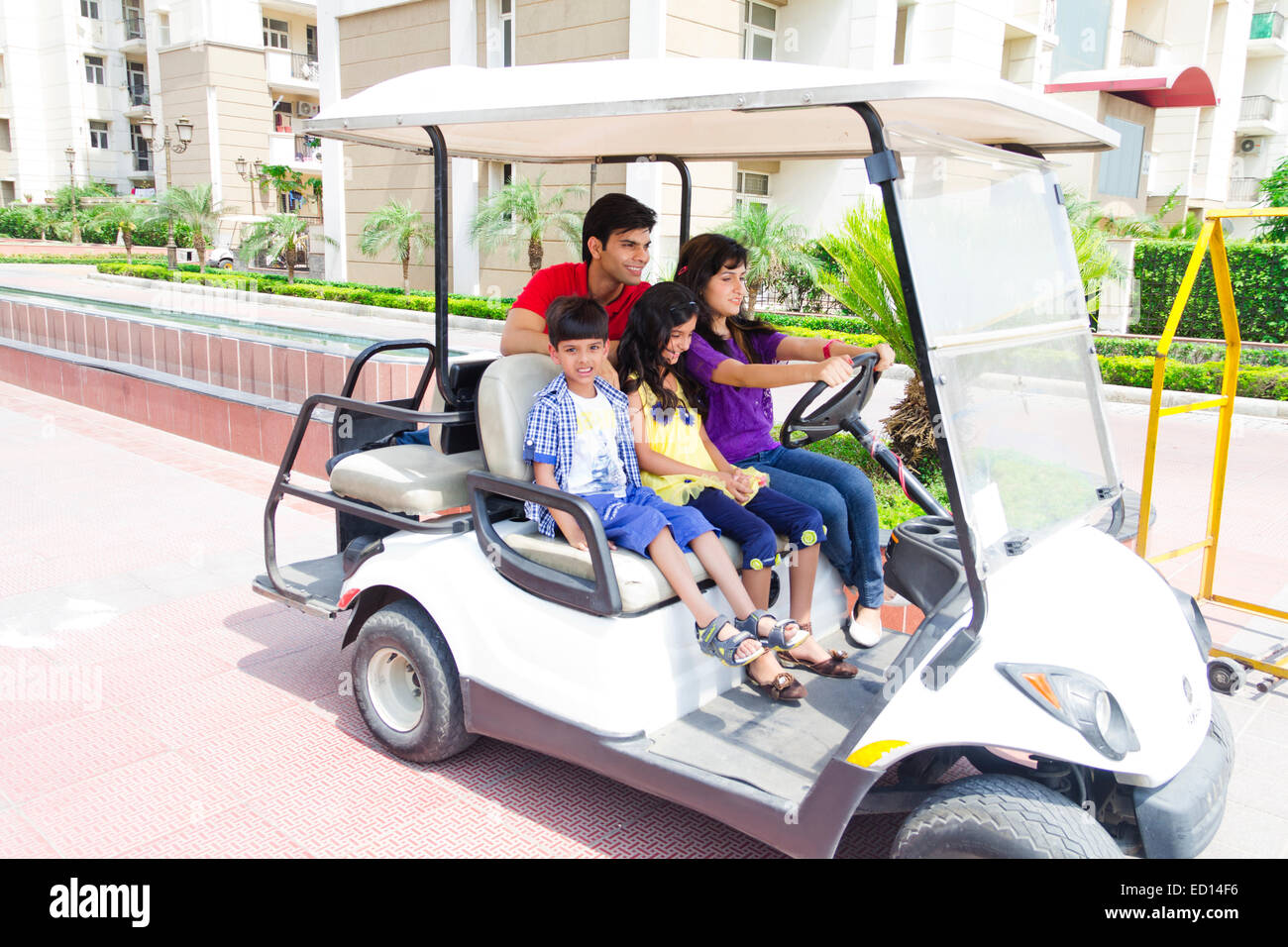 Indian i genitori con bambini parco equitazione carrello Foto Stock