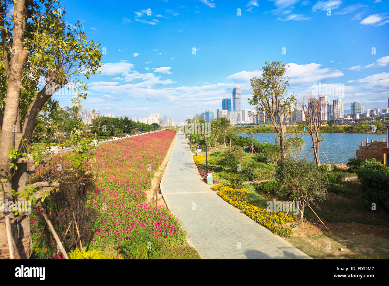 Vicolo della città con fiori e lanterne dal paesaggio urbano in background Foto Stock