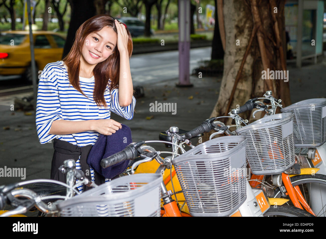 Donna in posa da U-bike noleggi biciclette; un'iniziativa di Taipei City per promuovere un trasporto ecologico Foto Stock