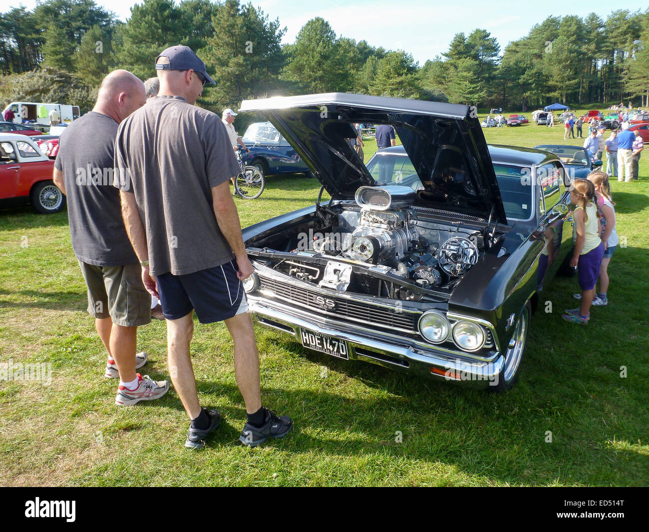 La folla ammirare un vintage American classic car in corrispondenza di un rally a Pembrey, Carmarthenshire, il Galles in ottobre 2014. Foto Stock