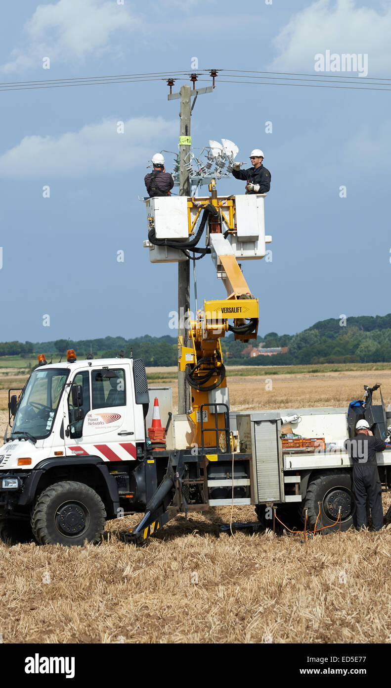 Regno Unito le reti di potere ingegneri elettrici lavorando su aggiornamento cablaggio tettuccio, Bawdsey, Suffolk, Regno Unito. Foto Stock