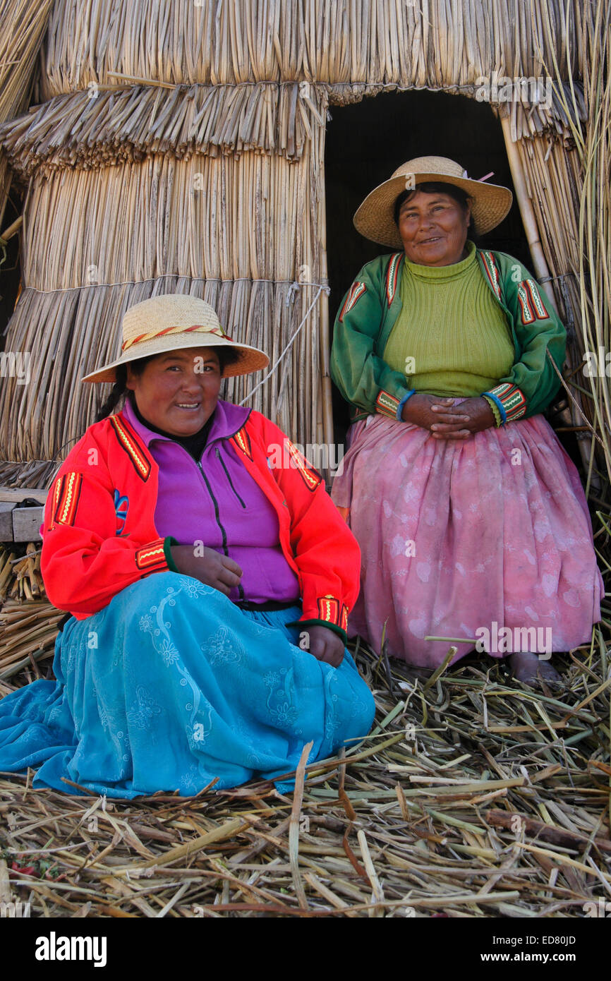 Due graziosi Uros le donne indiane sulla loro tortora reed isola, Puno, il lago Titicaca, Perù Foto Stock