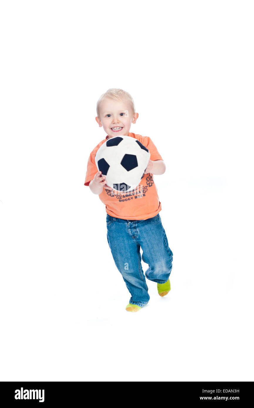 Ragazzo giocando in studio con calcio in schiuma Foto Stock