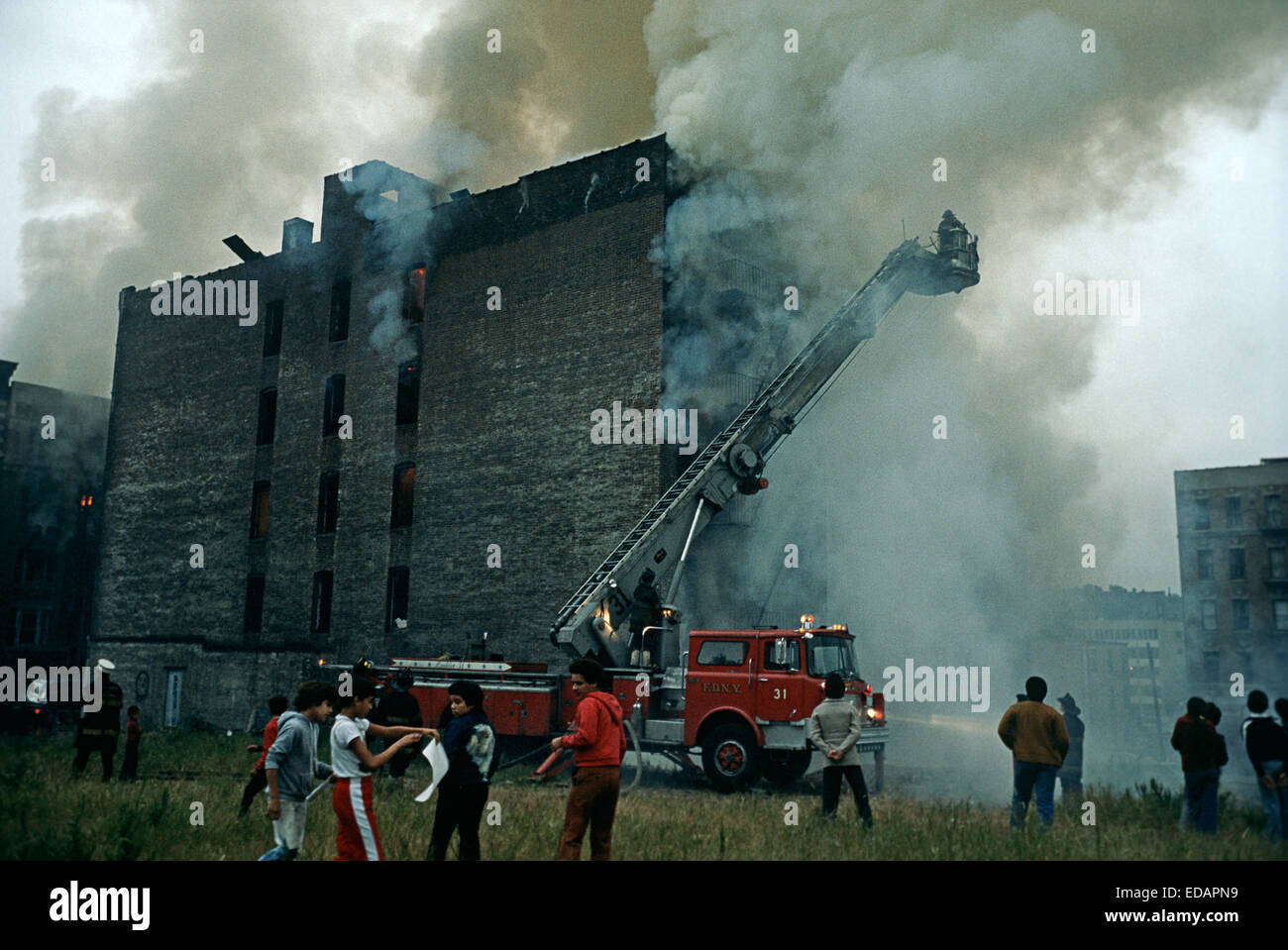 Stati Uniti d'America, Sud Bronx, NEW YORK CITY - agosto 1977. New York City per i vigili del fuoco di combattere il fuoco nel Sud Bronx abbandonato casamento. Foto Stock