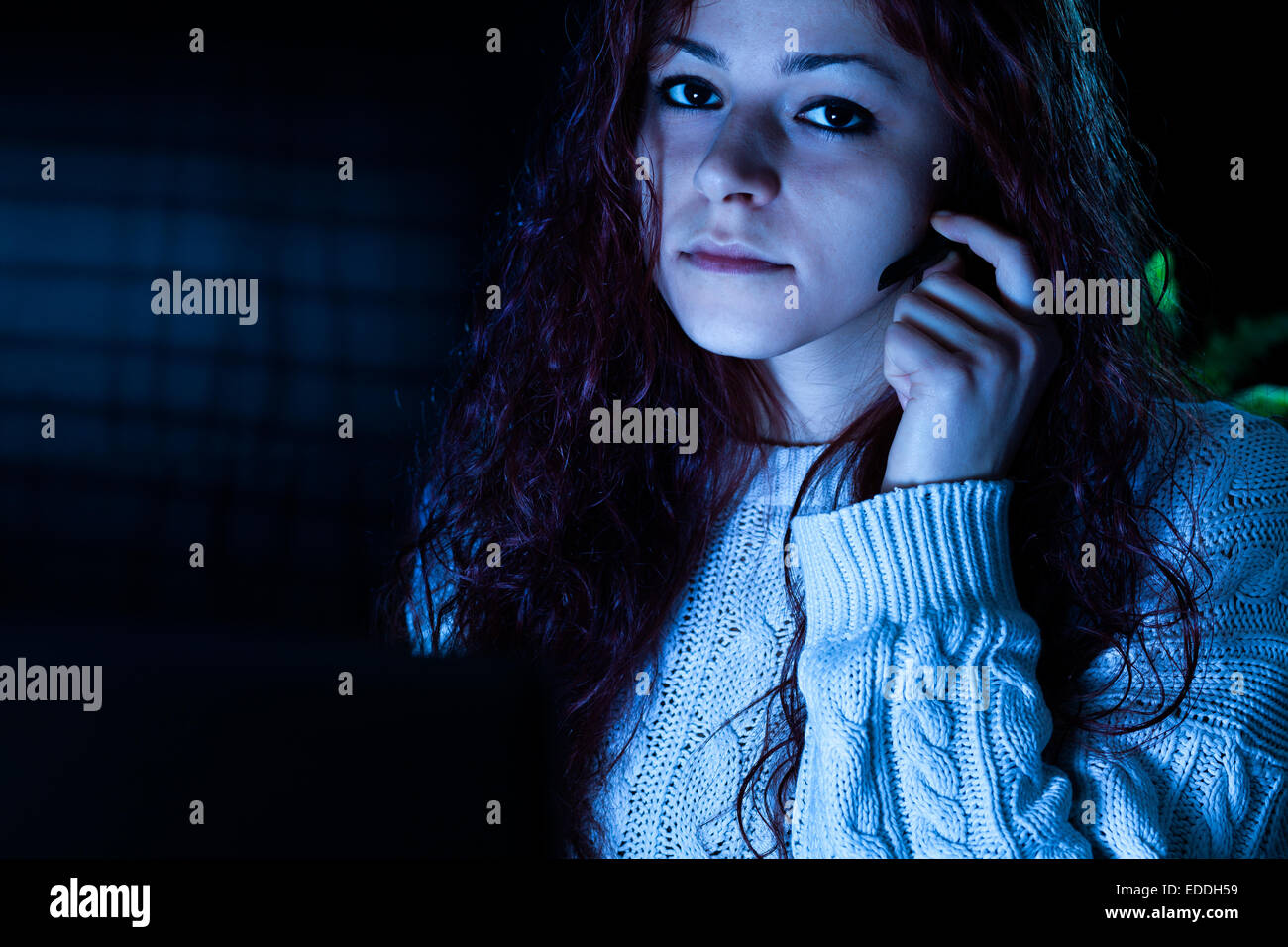 Donna che lavorano con un computer con cuffie di notte Foto Stock