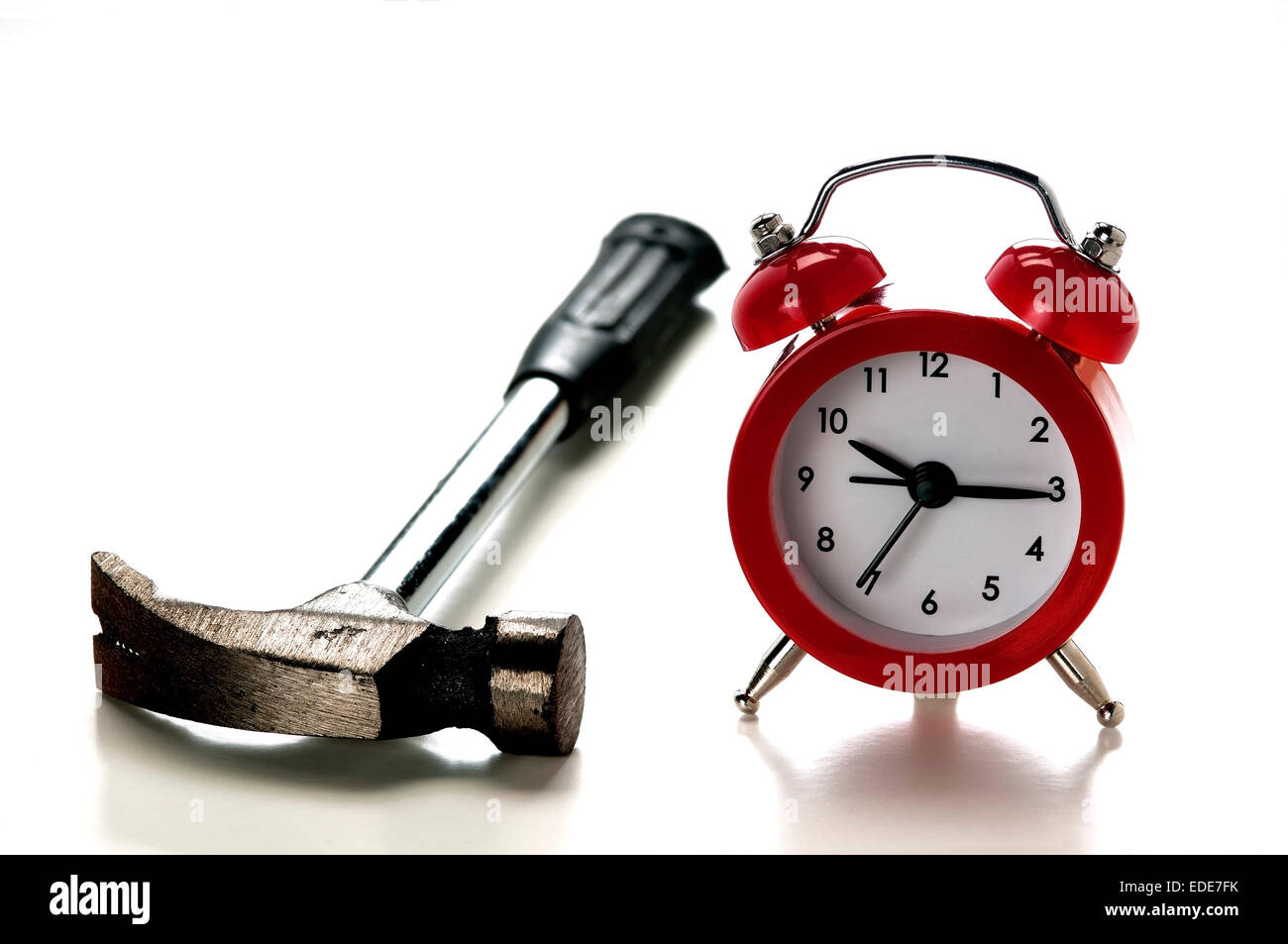 Un orologio e un martello, il concetto di disturbo che provoca la sveglia al mattino Foto Stock