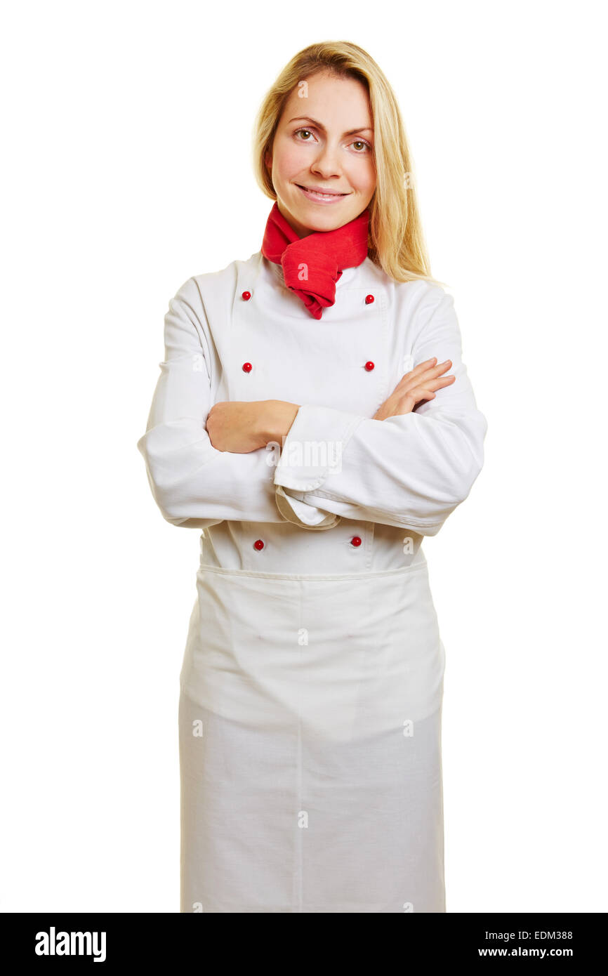 Giovane donna sorridente come cuoco in apprendistato con indumenti da lavoro Foto Stock