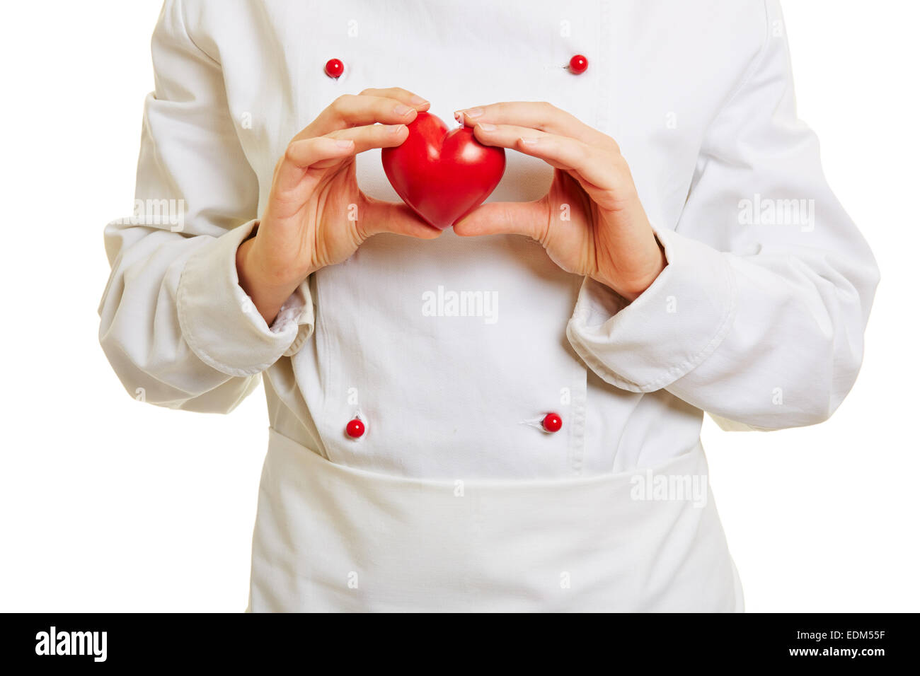 Chef di cucina tenendo un cuore rosso nella parte anteriore del workwear Foto Stock