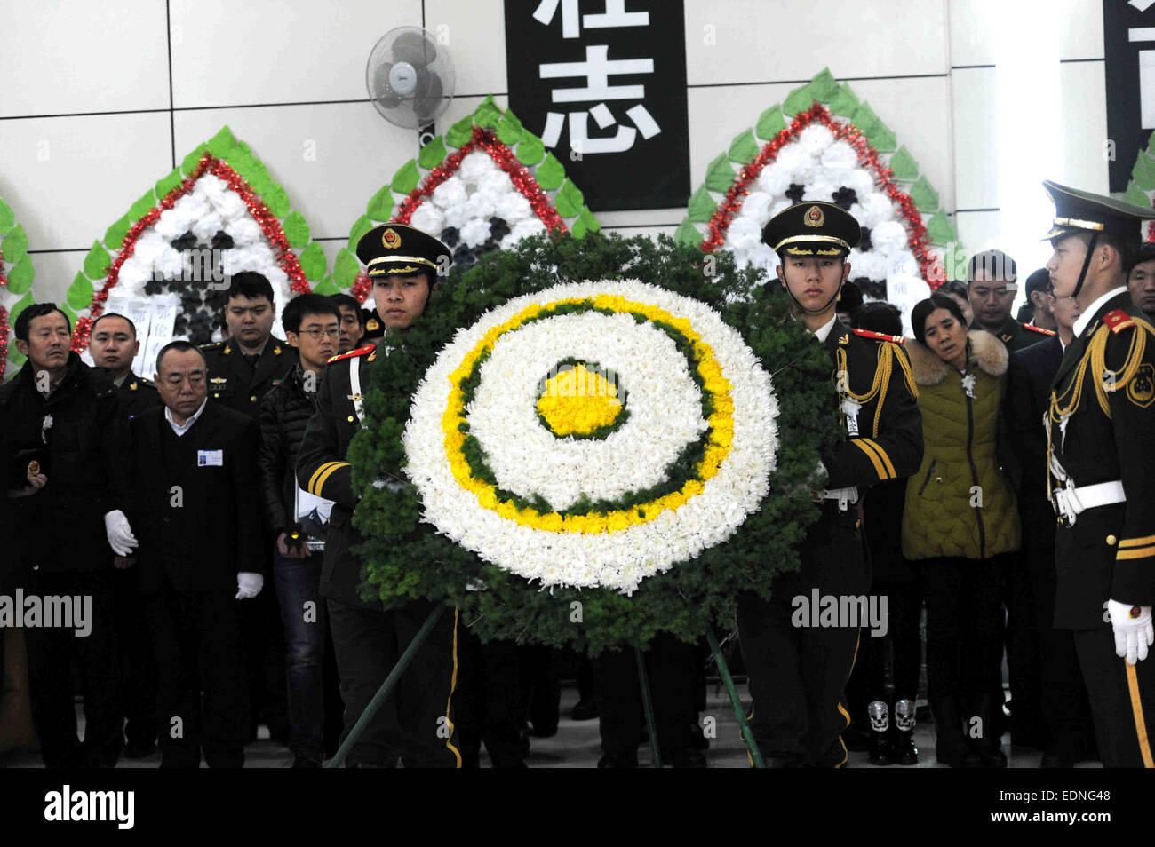 Harbin, la Cina della Provincia di Heilongjiang. 8 Gen, 2015. I soldati portano una corona al funerale di cinque vigili del fuoco a Harbin, capitale del nord-est della Cina di Provincia di Heilongjiang, 8 gennaio, 2015. Un grave incendio scoppiato in un magazzino a gennaio 2 a Harbin che ha ucciso cinque vigili del fuoco. Del defunto vigili del fuoco, il più giovane aveva 18 anni e il più antico 22. Credito: Wang Song/Xinhua/Alamy Live News Foto Stock
