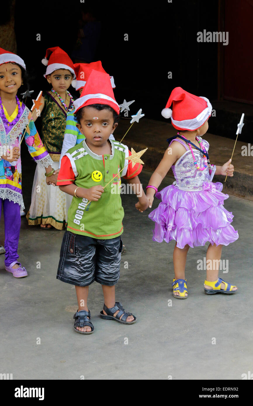 Ragazzi delle scuole festeggiano il Natale in Kerala, India indossando babbo natale costume Foto Stock