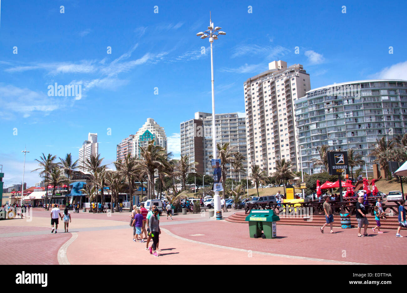 Molte persone sconosciute a piedi lungo la passeggiata sul 'Golden Mile' fronte spiaggia a Durban, Sud Africa Foto Stock