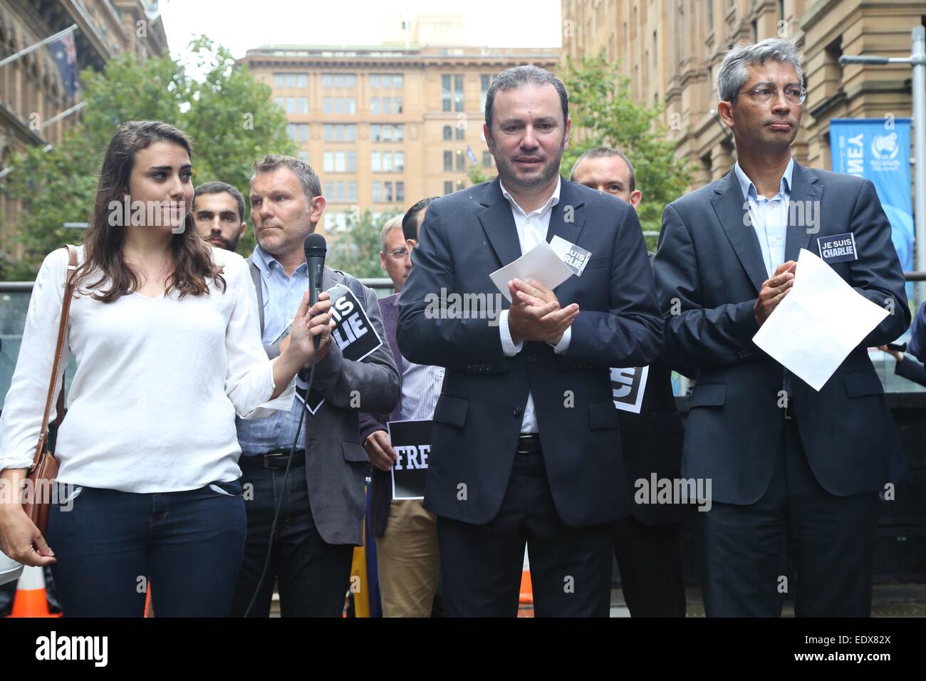 Sydney, Australia. 11 gennaio 2015. Il popolo francese a Sydney si sono riuniti a Martin Place per onorare le vittime del Charlie Hebdo attacco da parte di elementi di Al Qaeda. Essi detenute segni dicendo, "libertà" e "Je suis Charlie'. I nomi di coloro che erano morti sono stati letti e i messaggi sono stati scritti su una parete. Nella foto è una signora francese (in piedi accanto all'ambasciatore francese in Australia, Christophe Lecourtier) che la lettura dei nomi di coloro che sono stati uccisi in attacchi terroristici in Francia. Credito: credito Copyright: Richard Milnes/Alamy Live News Foto Stock