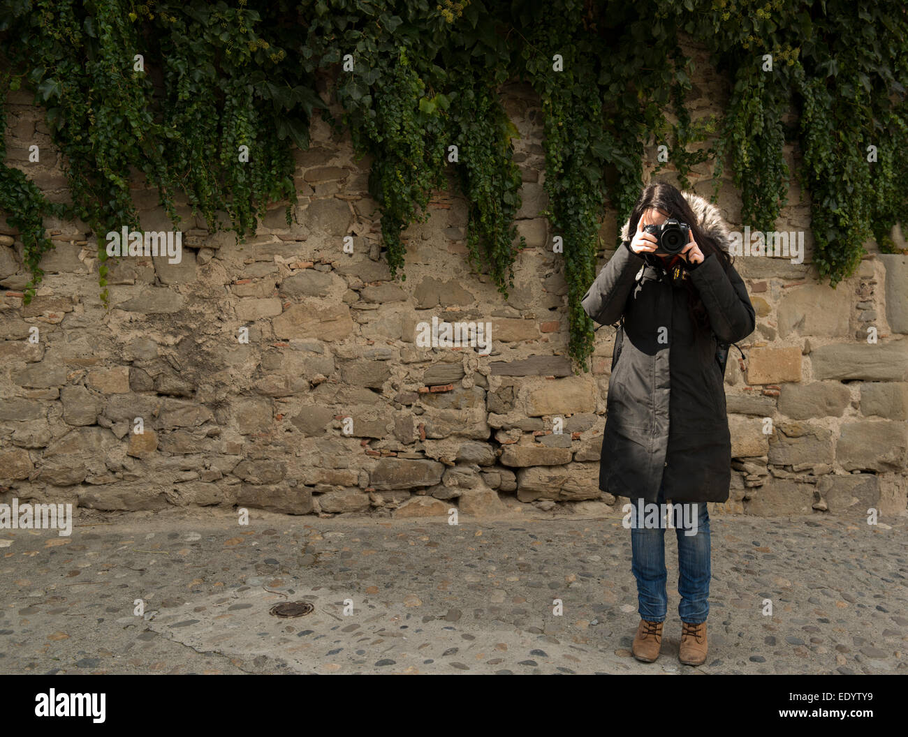 Femmina usando Nikon fotocamera reflex dslr lungo cappotto. Credito: lee ramsden / alamy Foto Stock