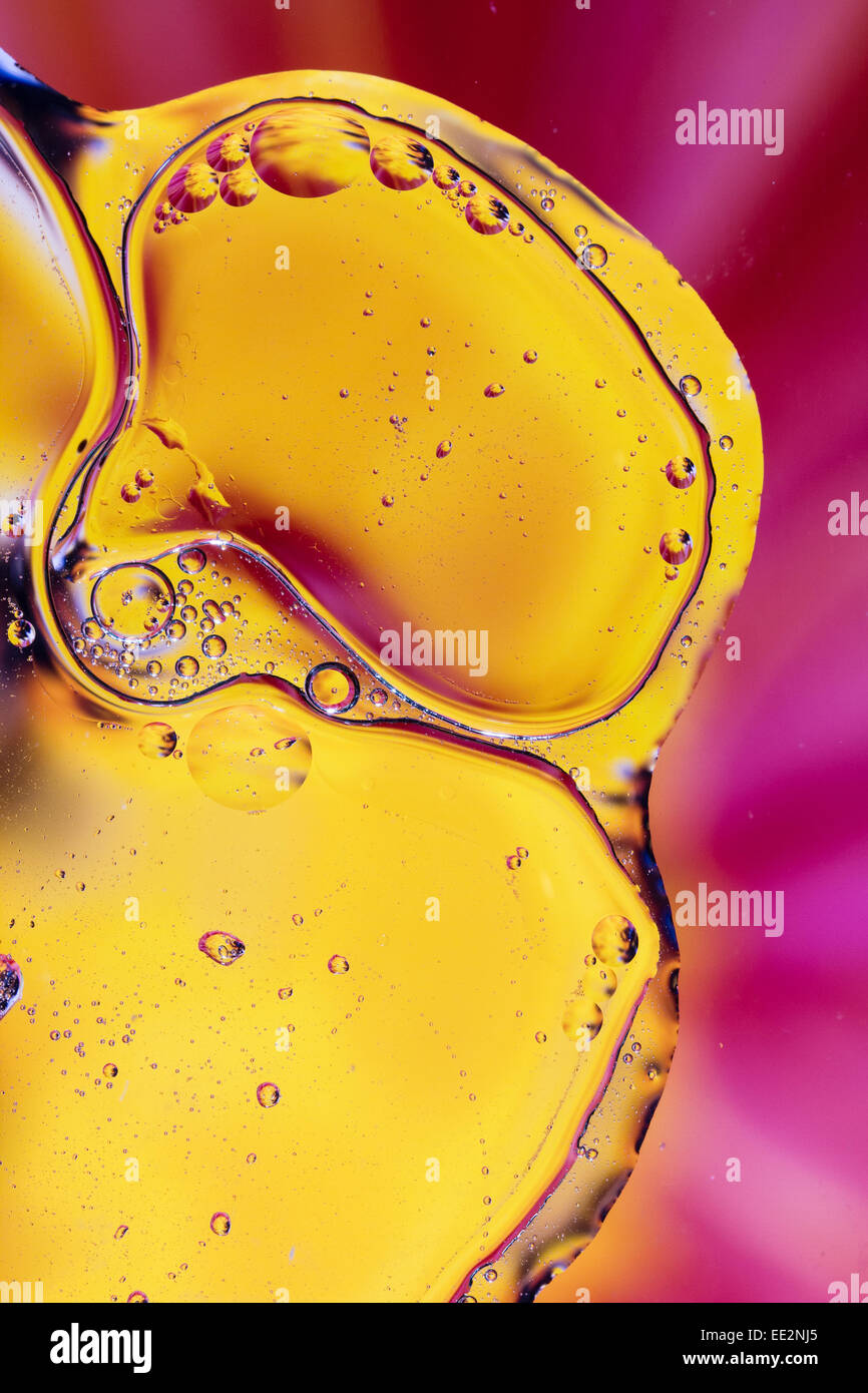 Olio astratto e pattern di acqua. Giallo dorato e sfondo rosa forme. Foto Stock