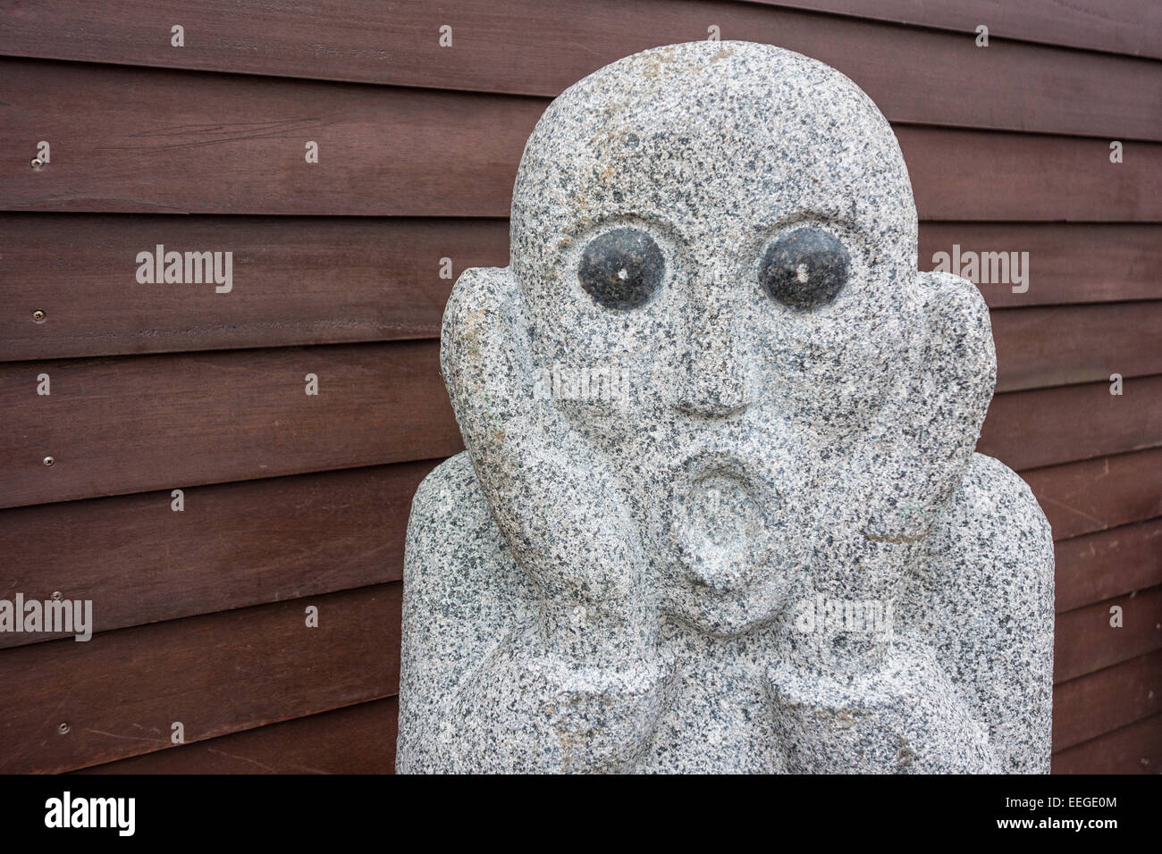 La scultura di fronte ad una parete in legno. Foto Stock