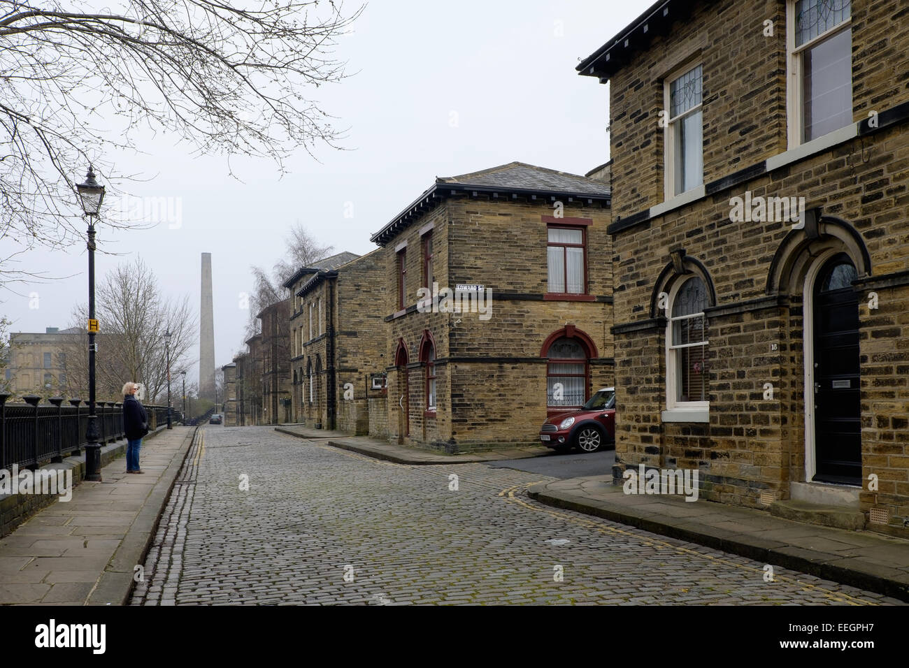 Uno del Vittoriano strade di ciottoli con mattoni costruito case nella città di Mulino di Saltaire, nello Yorkshire, Regno Unito. Foto Stock