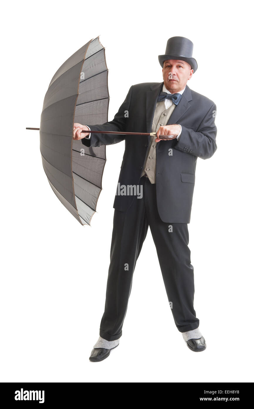Persone di mezza età imprenditore in un retrò business suit con ombrellone isolato su bianco. Foto Stock