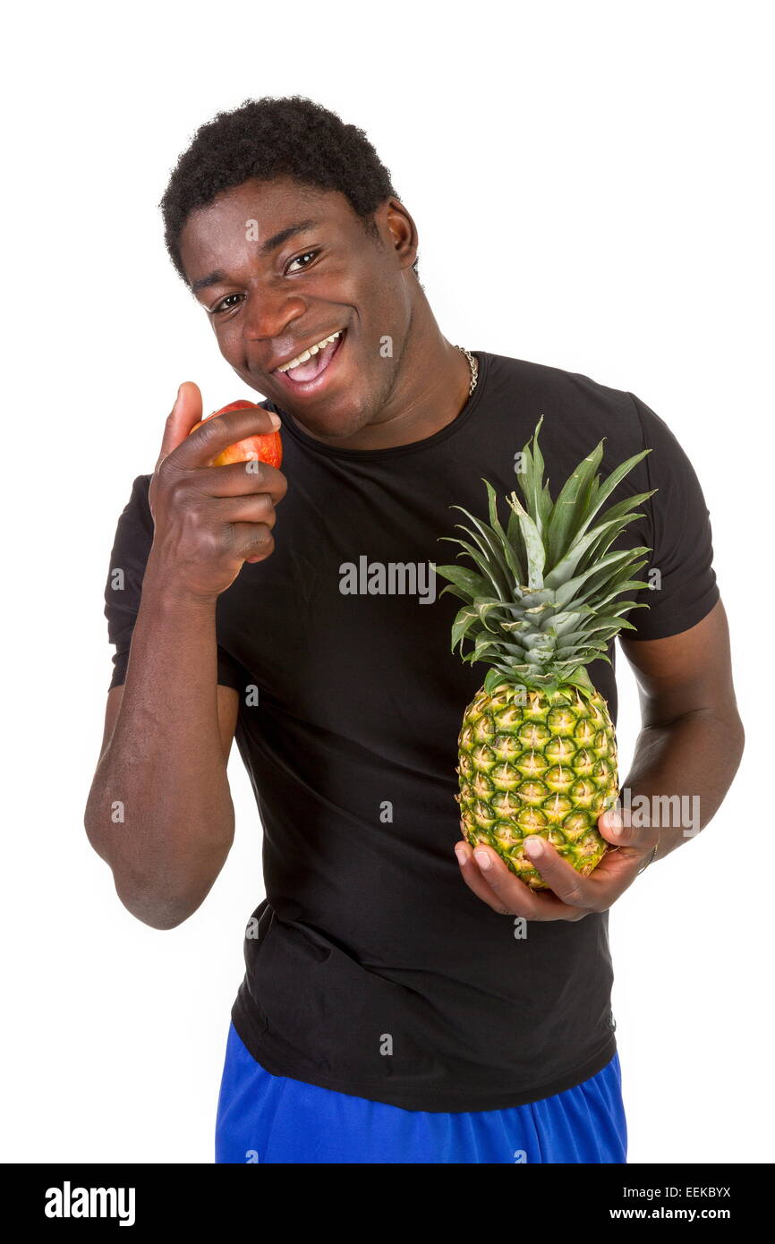 Junger dunkelhäutiger Mann nel Sportkleidung mit Obst Foto Stock