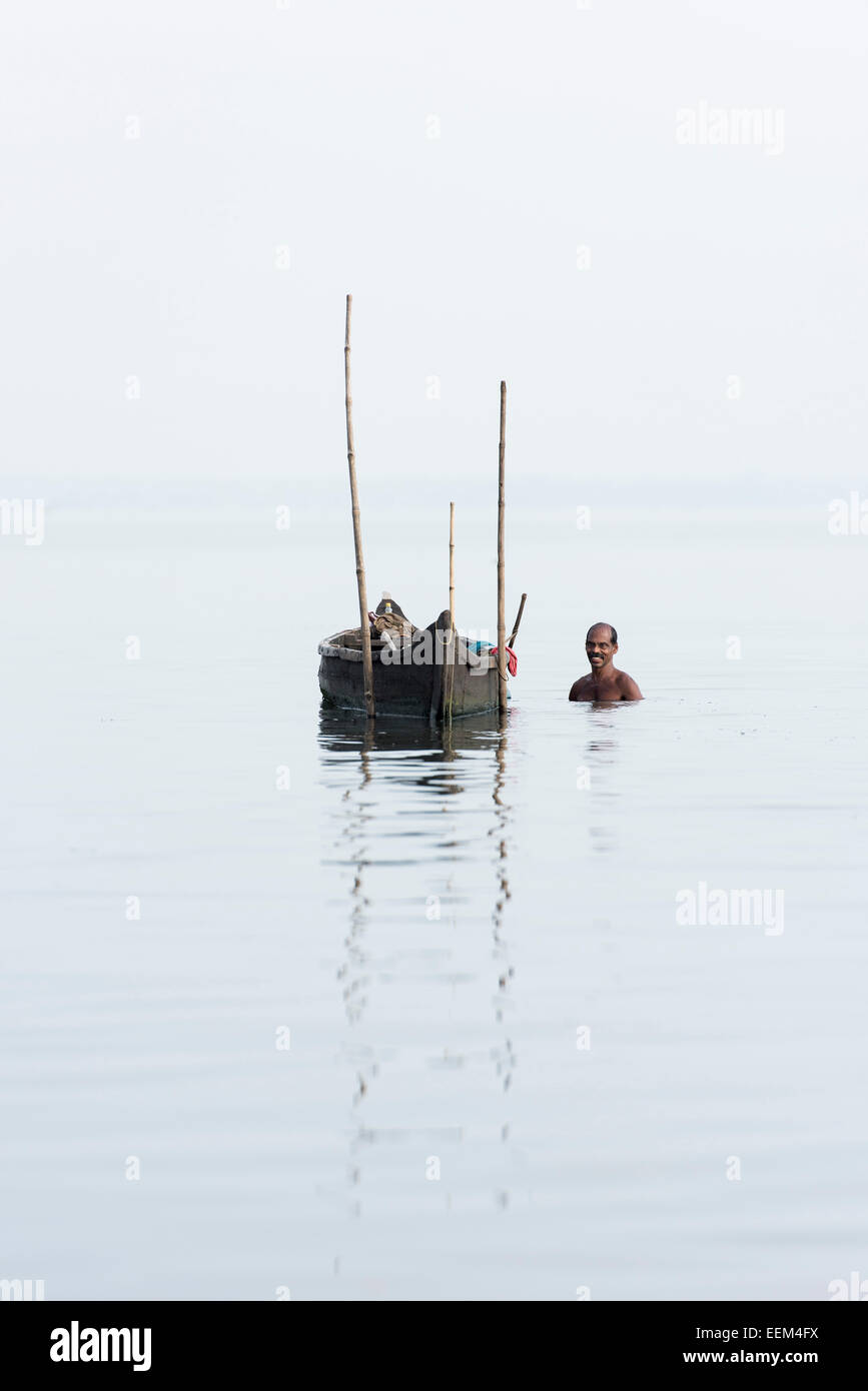 Il Cockle picker a bordo della sua barca, Lago Vembanad, Kerala, India Foto Stock