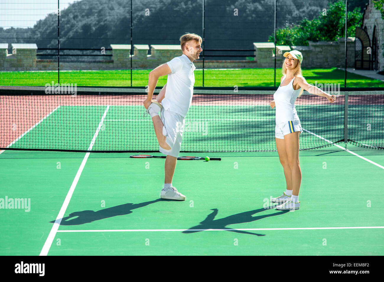 Coppia giovane la formazione sul campo da tennis Foto Stock