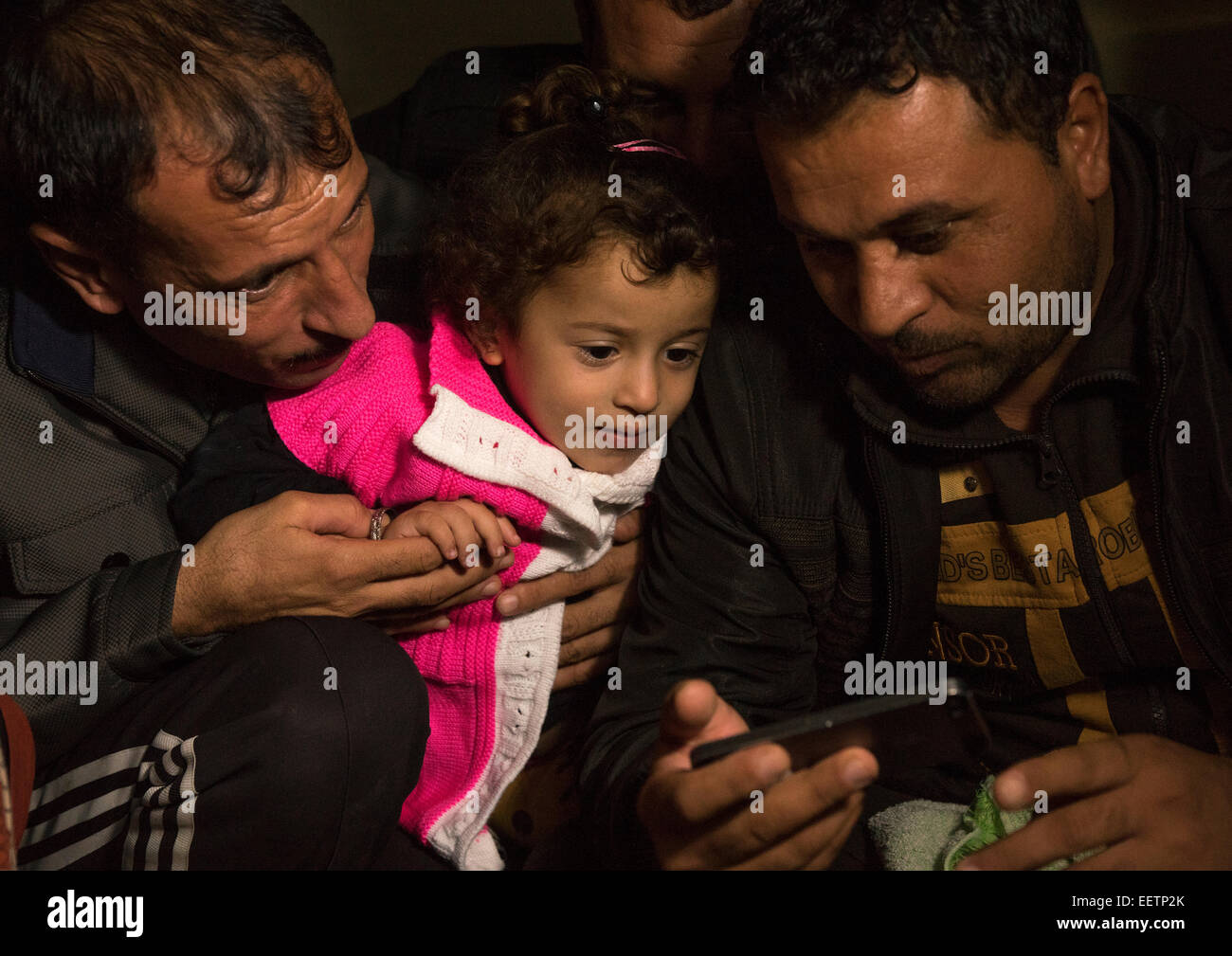 Yezedi rifugiati da Sinjar facendo una conferenza su un telefono mobile con i parenti, Zocar, Kurdistan, Iraq Foto Stock