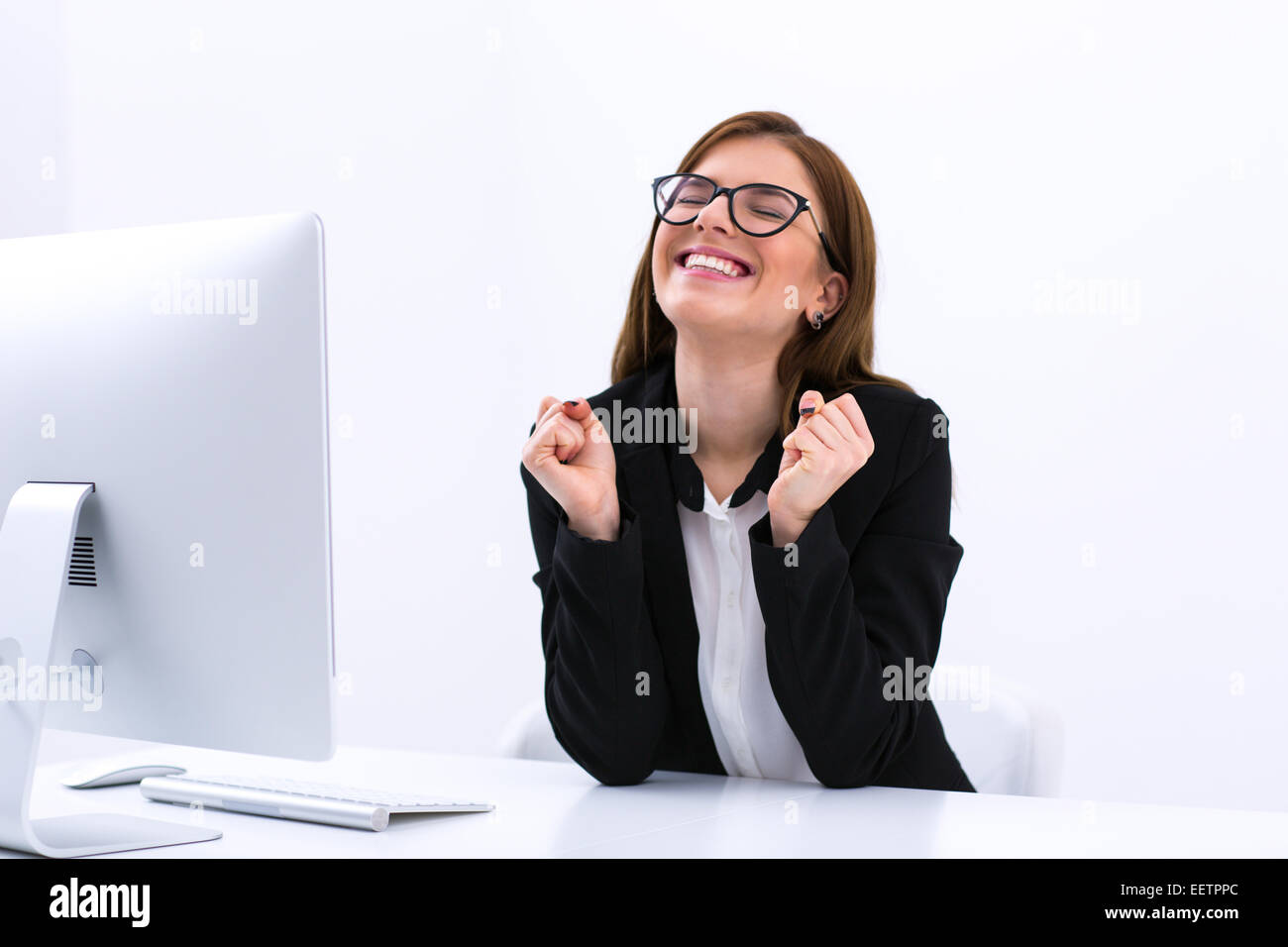 Business di successo di donna seduta al suo posto di lavoro in ufficio Foto Stock