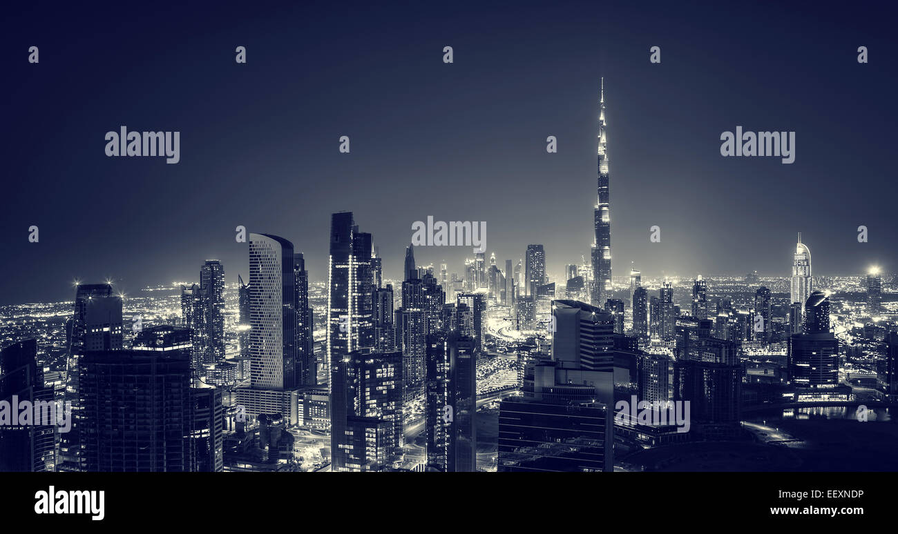 Bella città di Dubai di notte, maestoso paesaggio urbano incandescente nel buio notturno, splendida architettura moderna, viaggi di lusso Foto Stock