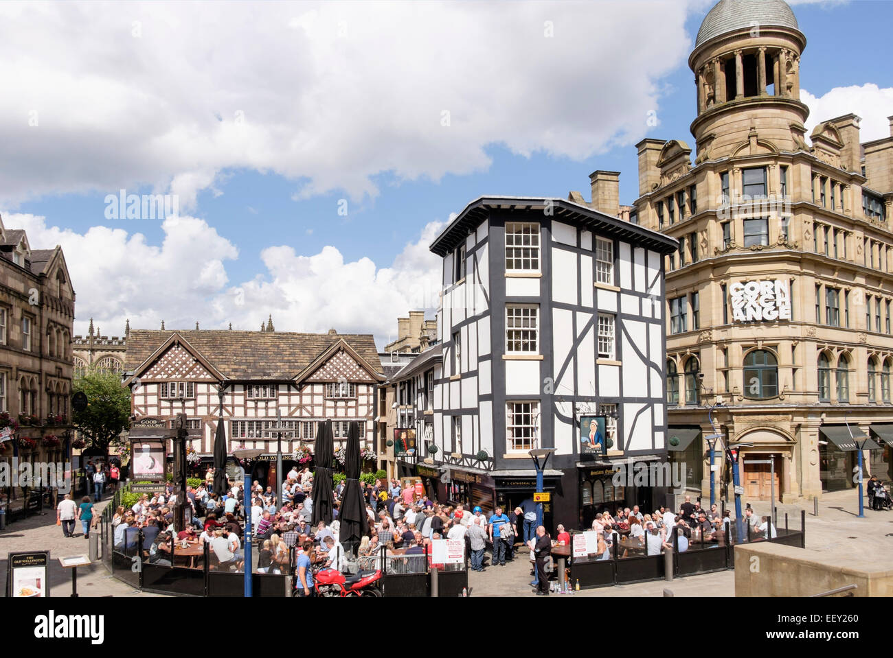 Il vecchio Wellington Inn 1552 è un edificio in legno del XVI secolo con una folla di clienti in un'affollata birreria all'aperto. Manchester Inghilterra Gran Bretagna Foto Stock