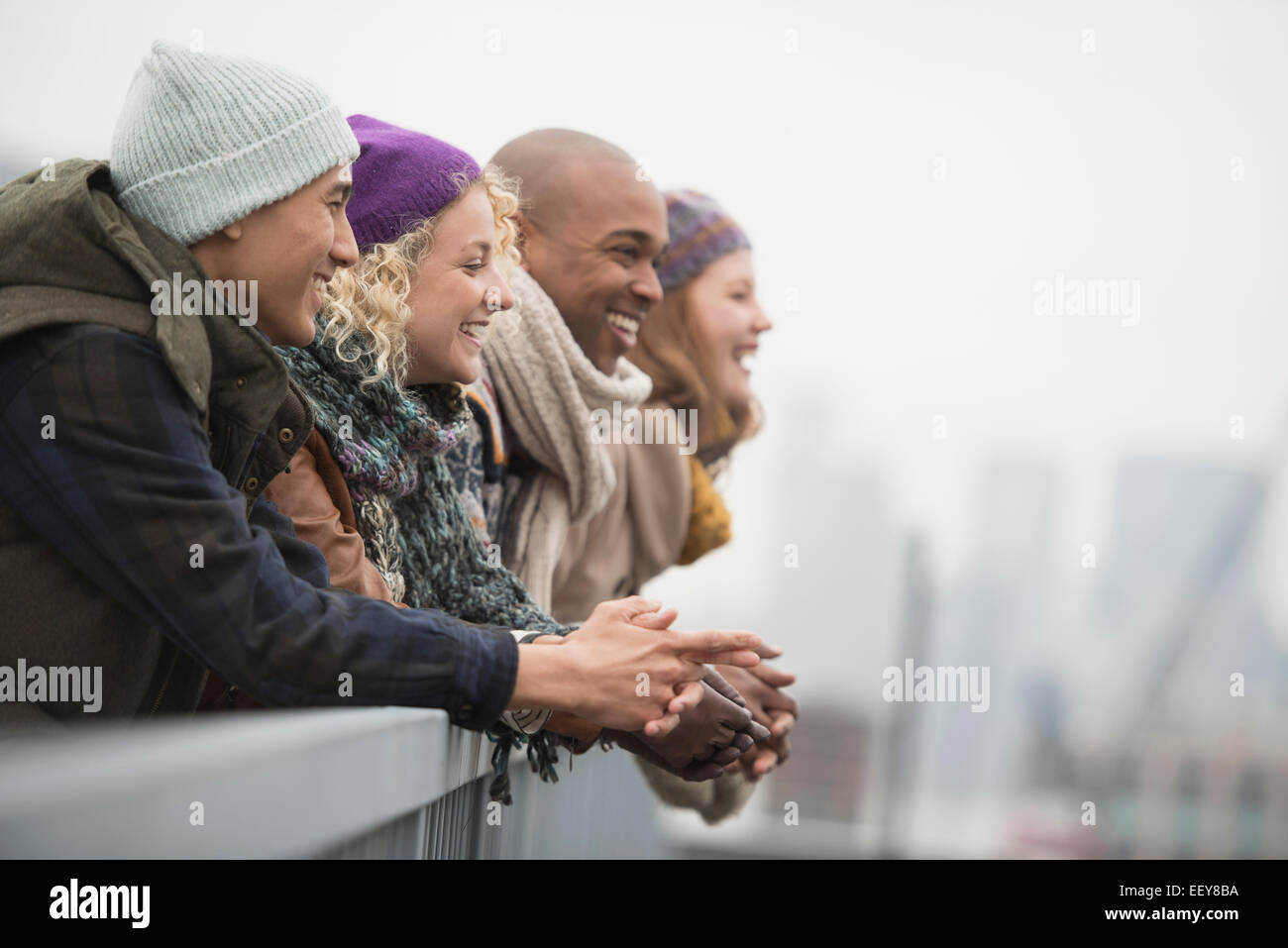 Amici in piedi sul ponte e ridere Foto Stock