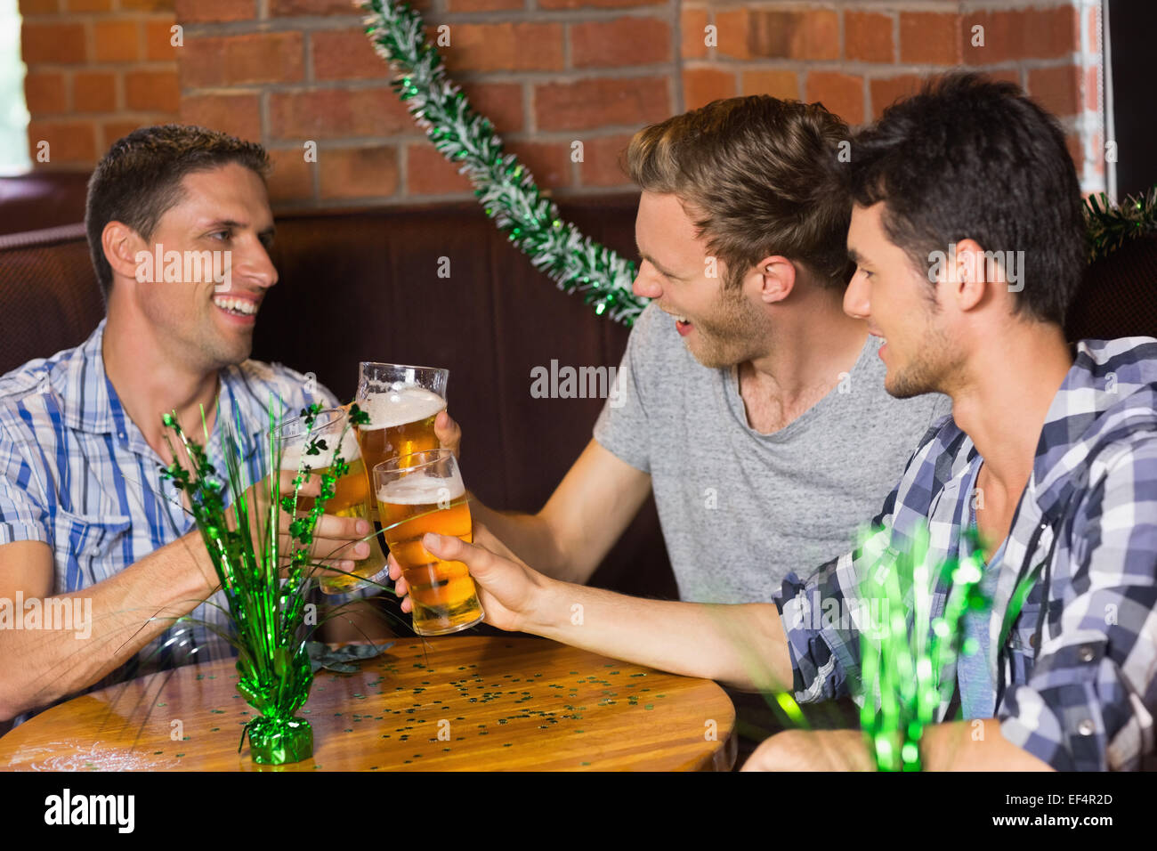 Happy amici bevendo pinte di birra su patricks giorno Foto Stock