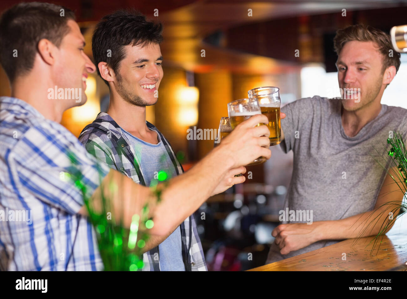 Happy amici bevendo pinte di birra su patricks giorno Foto Stock