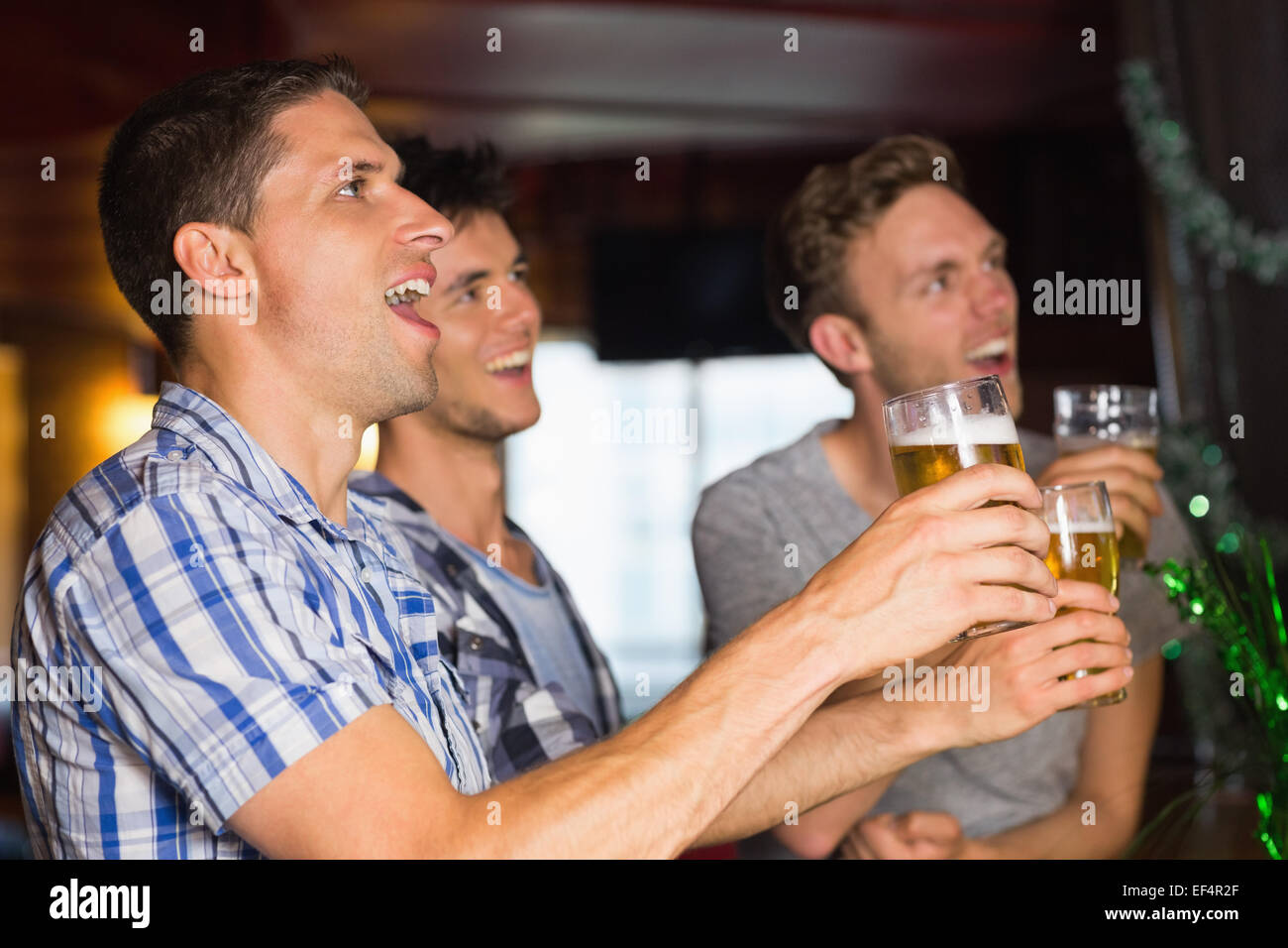 Happy amici bevendo pinte di birra su patricks giorno Foto Stock