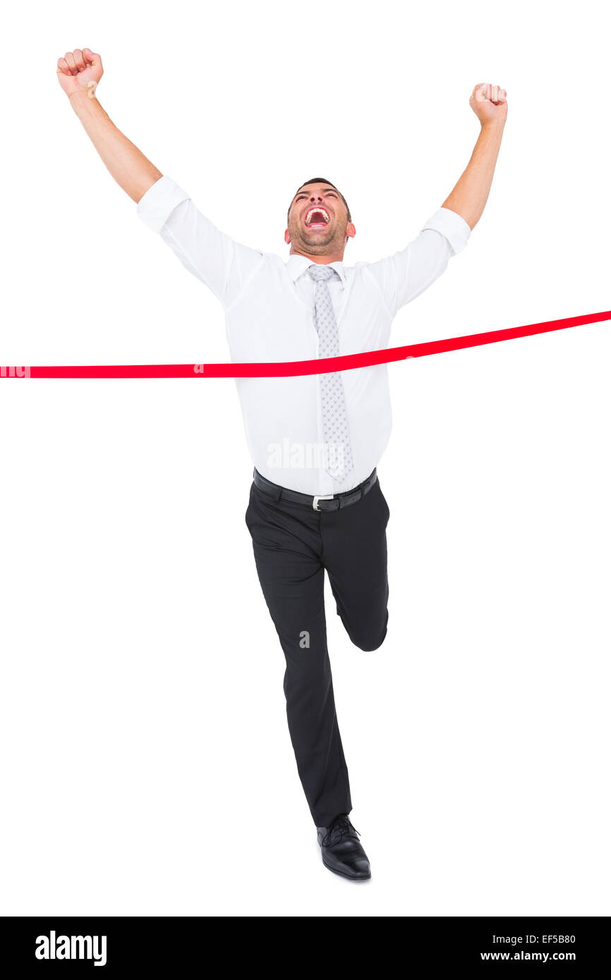 Imprenditore attraversando il traguardo Foto Stock