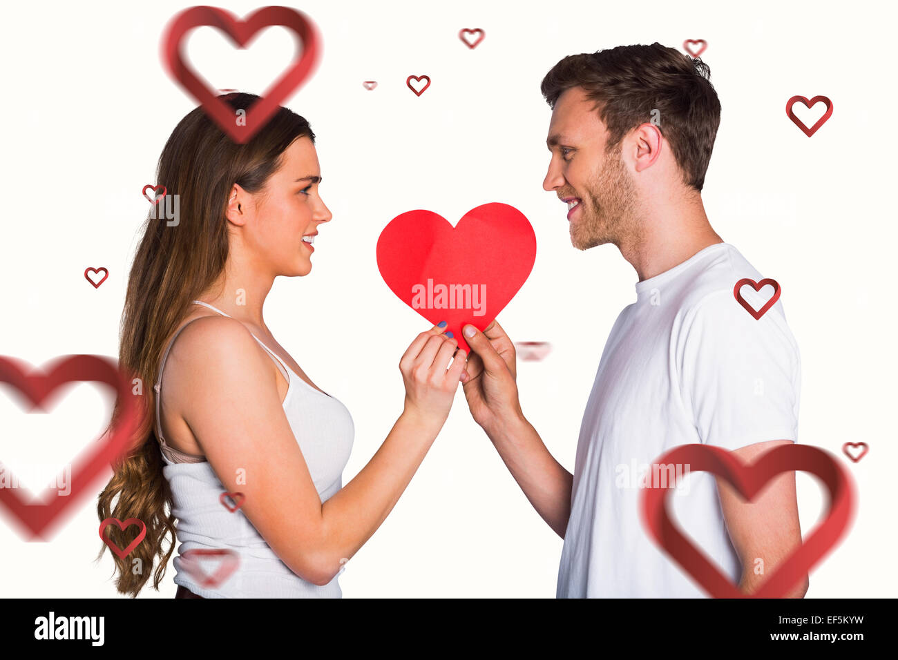 Immagine composita della romantica coppia giovane azienda cuore Foto Stock