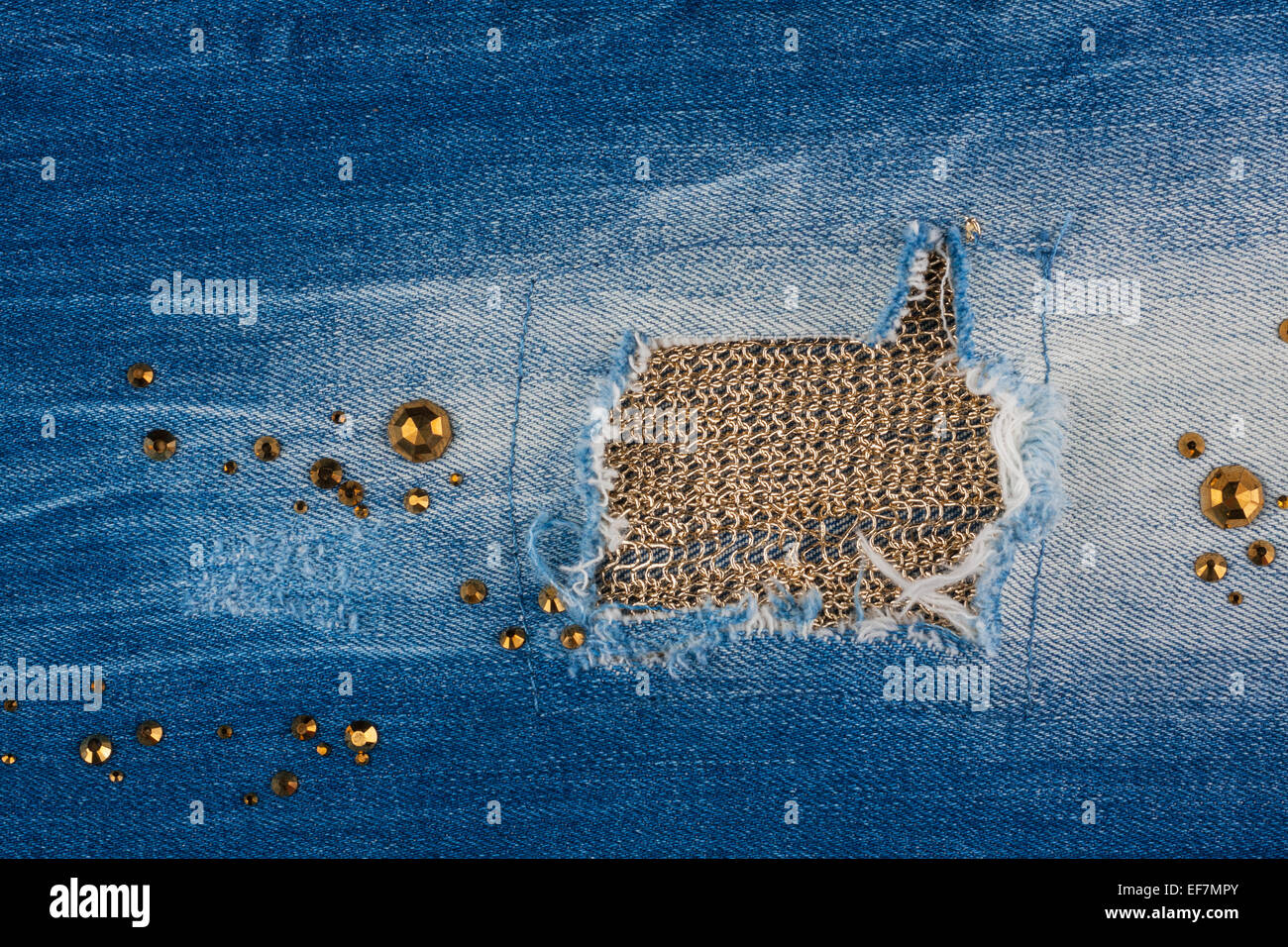 Light blue jeans strappati con strass e oro filato, con spazio per il testo Foto Stock