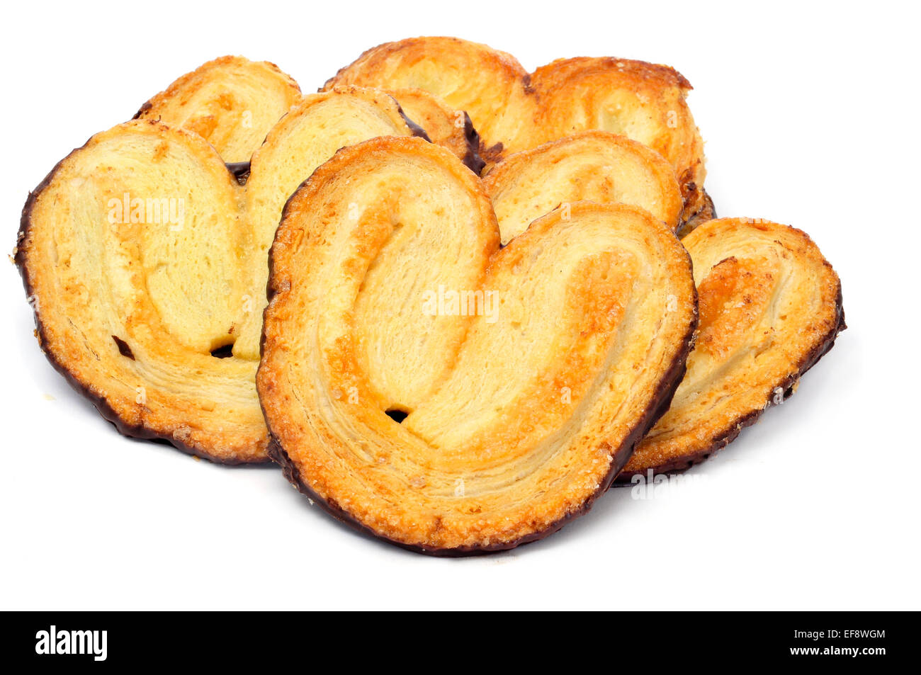 Alcuni palmeras, spagnolo palmier pasticcini, rivestiti con cioccolato in retro, su sfondo bianco Foto Stock