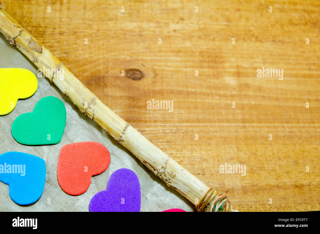 Grappolo di cuori colorati sul bordo di un legno storto cornice immagine Foto Stock