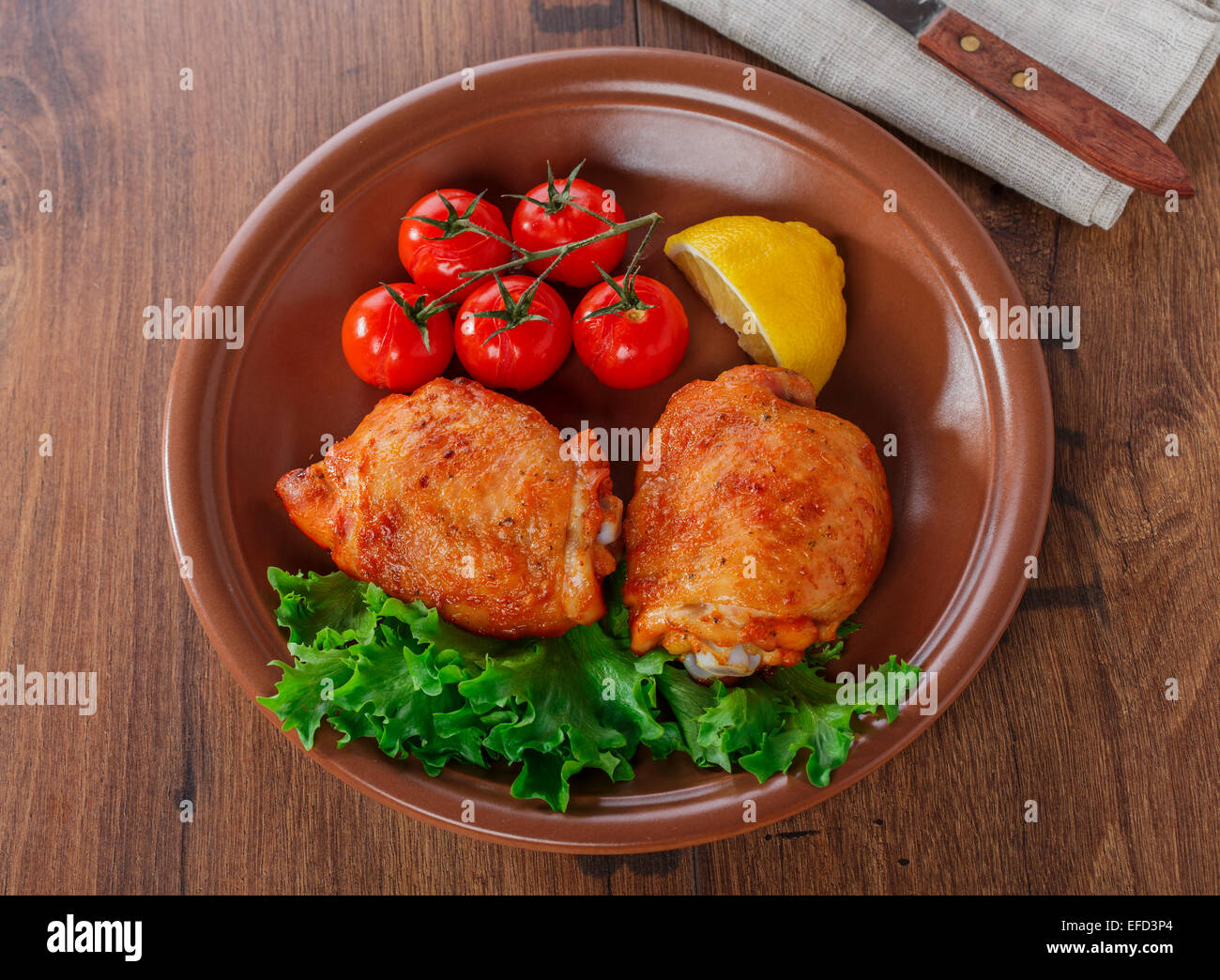 Cotto coscia di pollo con pomodorini e limone Foto Stock