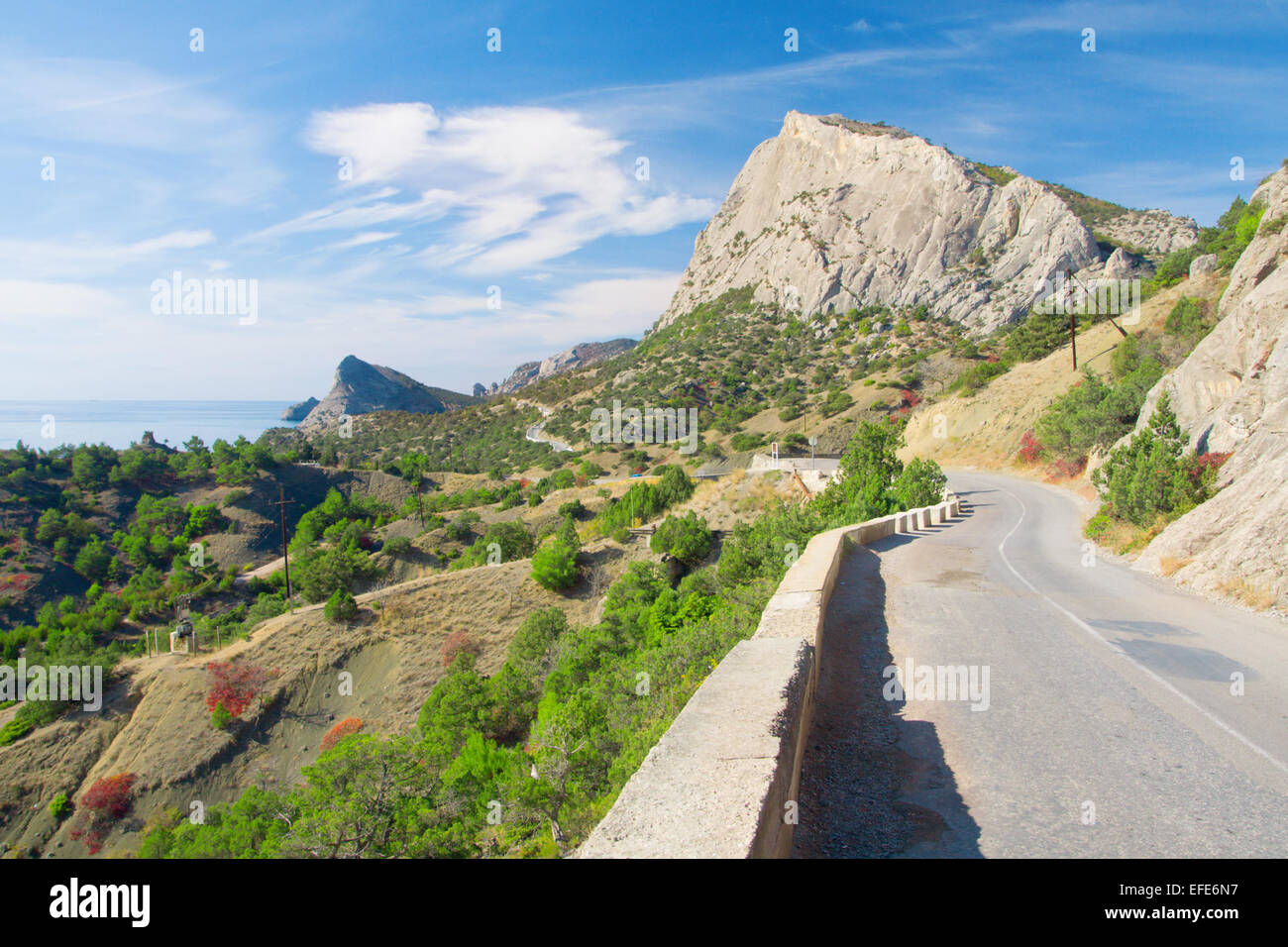 Strada tortuosa con la montagna e il mare blu Foto Stock