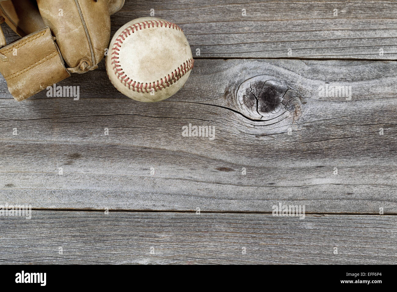 Parte superiore orizzontale angolo di vista del vecchio baseball e stagionato guanto in pelle su legno rustico Foto Stock