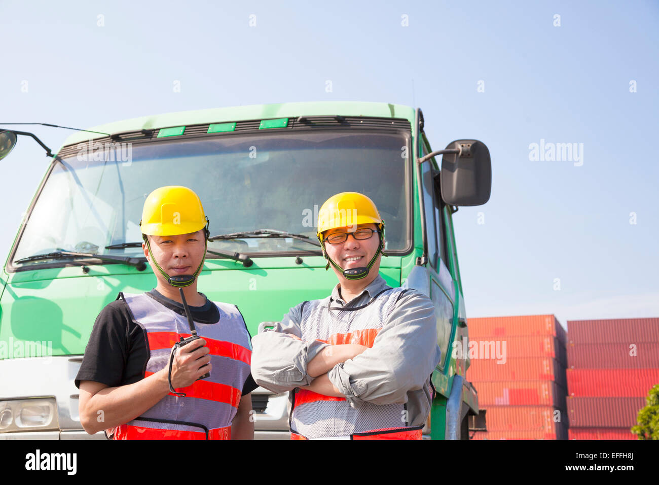 Due lavoratori di contenitore con un carrello Foto Stock
