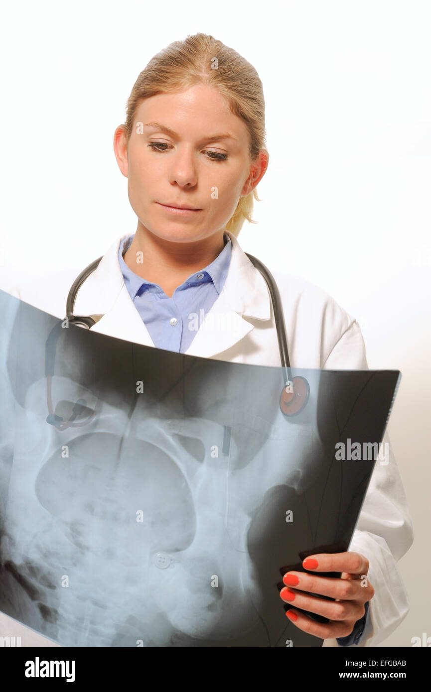 Medico donna esamina un'immagine a raggi x Foto Stock