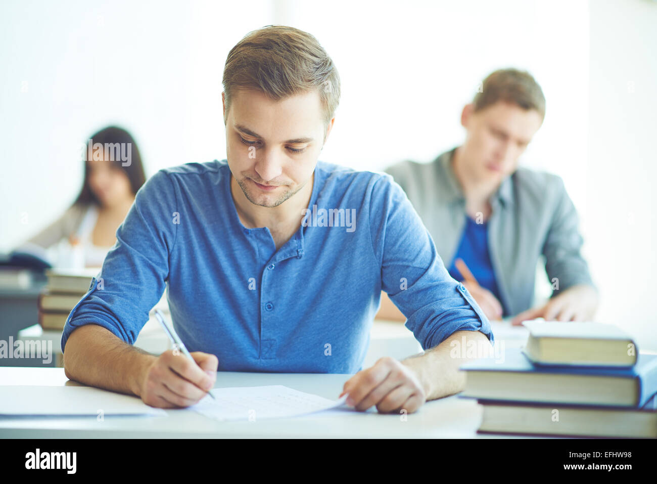 Serious student during written exam Foto Stock