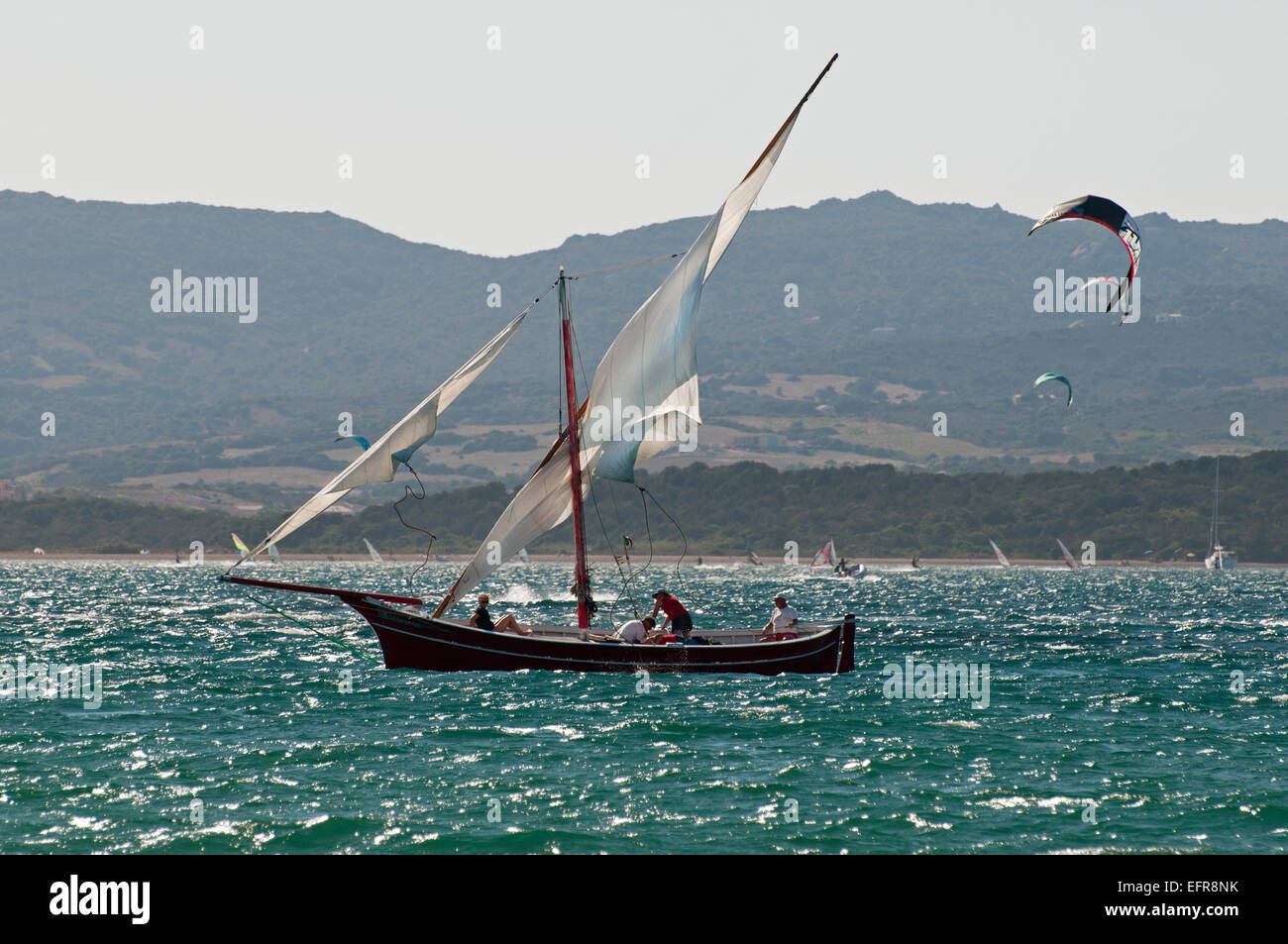 Latine (Latino) barche a vela e equipaggio sul mare vicino alla costa di Palau, Gallura, lato nord-est della Sardegna, Italia Foto Stock