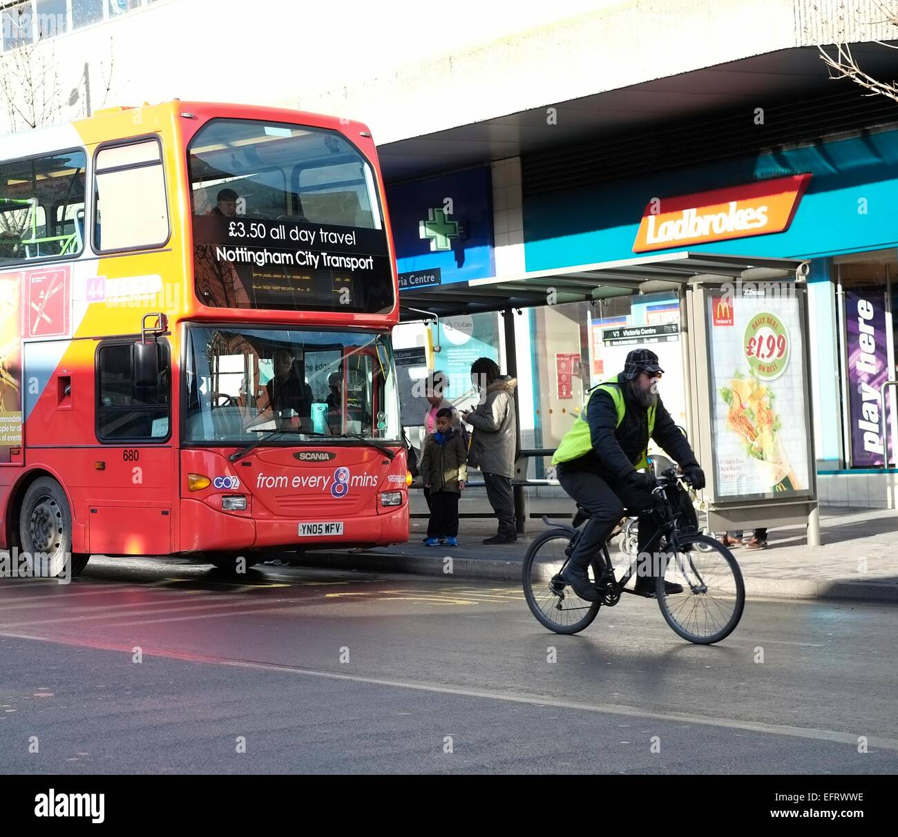 Un nottingham city bus trasporto preleva i passeggeri come un ciclista passa da England Regno Unito Foto Stock
