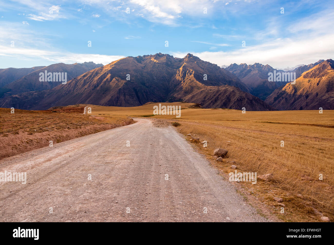 Strada sterrata con le montagne delle Ande in aumento dello sfondo nella Valle Sacra vicino a Cusco, Perù Foto Stock