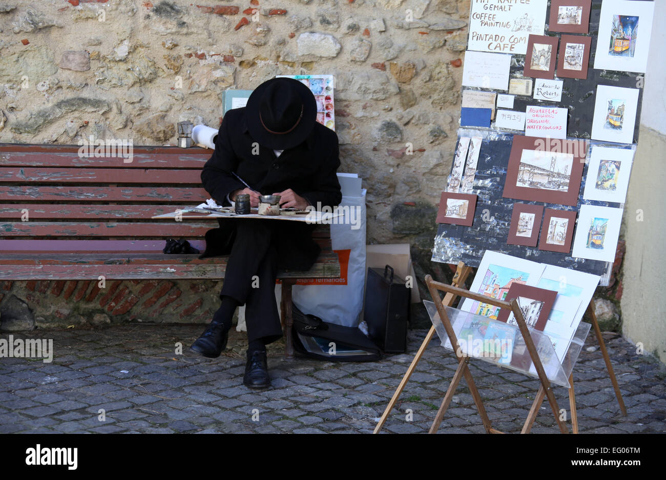 Artista di strada a Lisbona che dipinge con caffè Foto Stock