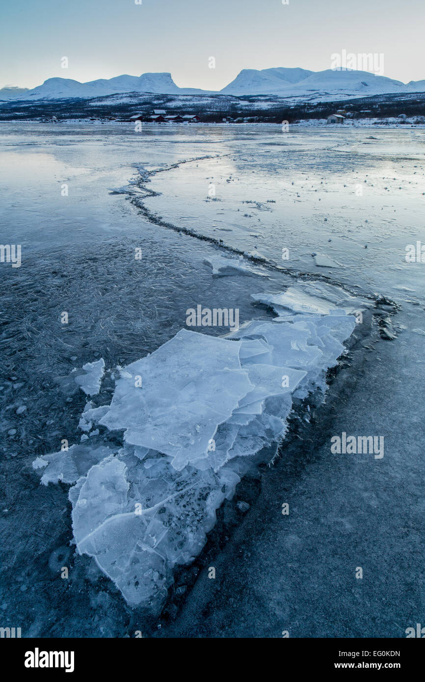 La Svezia, Lapponia, lago ghiacciato di Tornetrask con il crack che conduce alla montagna di Lapporten Foto Stock